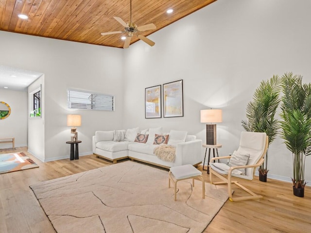 living room featuring wood ceiling, high vaulted ceiling, light wood-type flooring, and ceiling fan