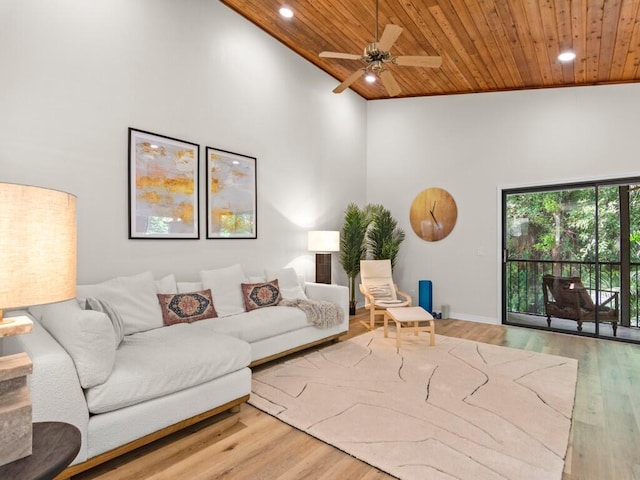 living room featuring wood ceiling, hardwood / wood-style flooring, high vaulted ceiling, and ceiling fan