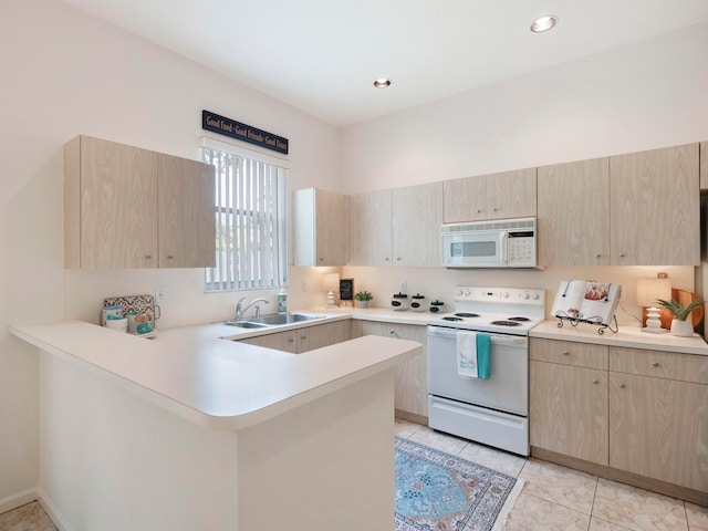 kitchen featuring kitchen peninsula, light brown cabinetry, white appliances, sink, and light tile patterned floors