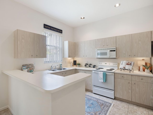 kitchen featuring a sink, white appliances, and light brown cabinets