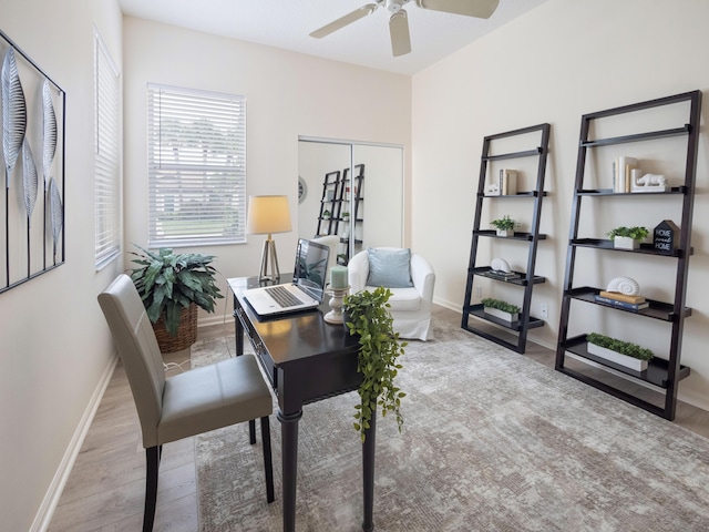 home office featuring ceiling fan, baseboards, and wood finished floors