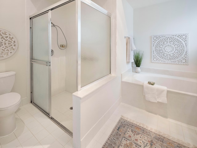 bathroom with tile patterned floors, separate shower and tub, and toilet