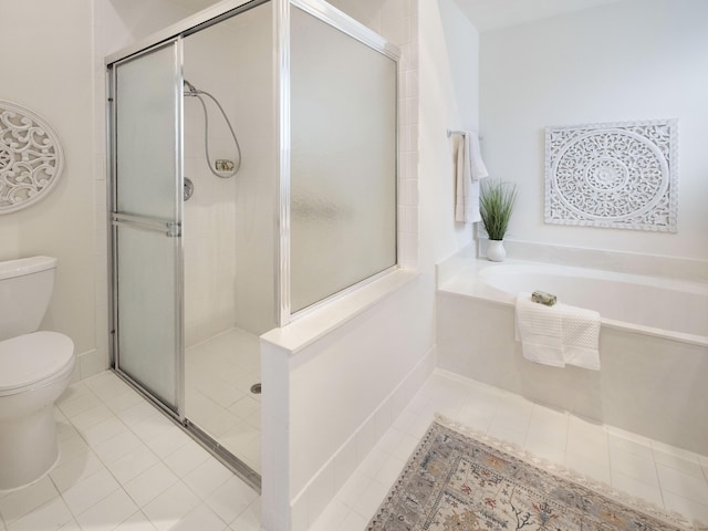 bathroom featuring a stall shower and toilet