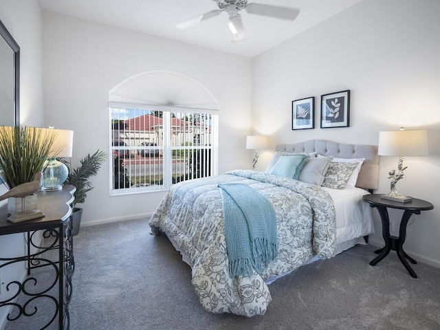 bedroom with ceiling fan and dark carpet