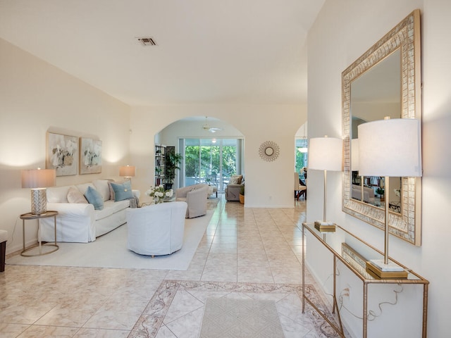 tiled living room with ceiling fan