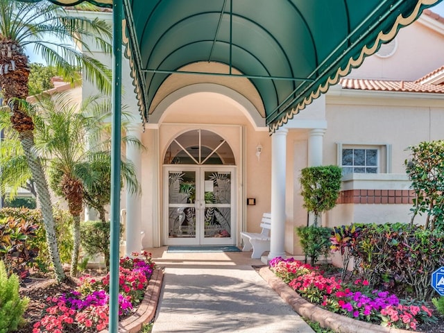 entrance to property with french doors and stucco siding