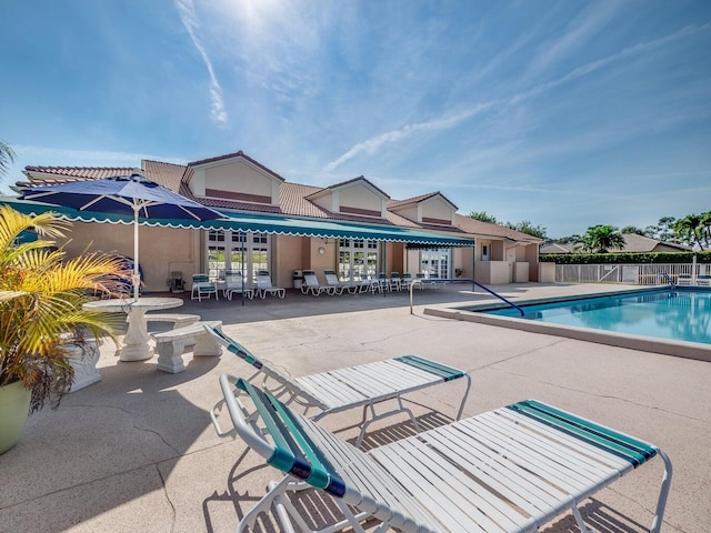 pool featuring a patio and fence