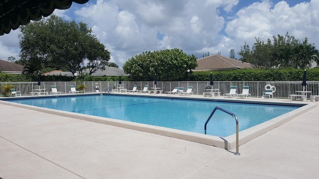 pool with fence and a patio