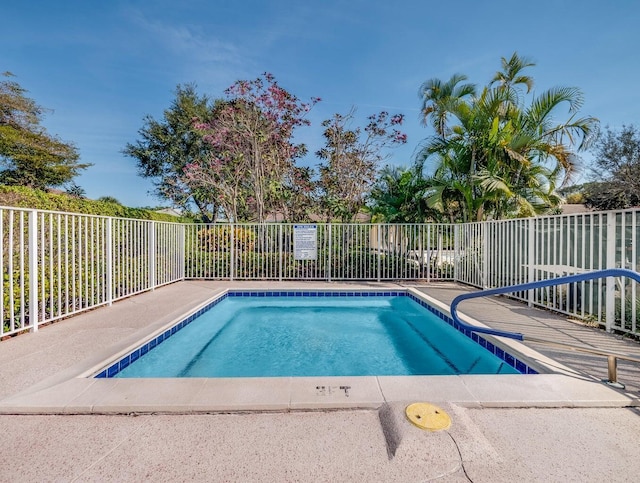 view of swimming pool with a swimming pool and fence