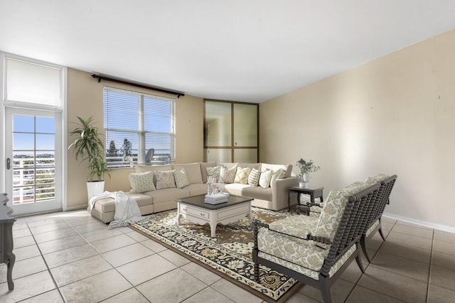 living room featuring a healthy amount of sunlight, baseboards, and light tile patterned floors