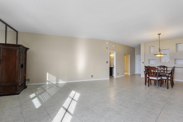 living area with light tile patterned floors and baseboards