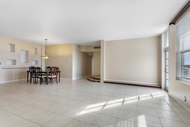 dining space featuring light tile patterned floors, visible vents, and baseboards