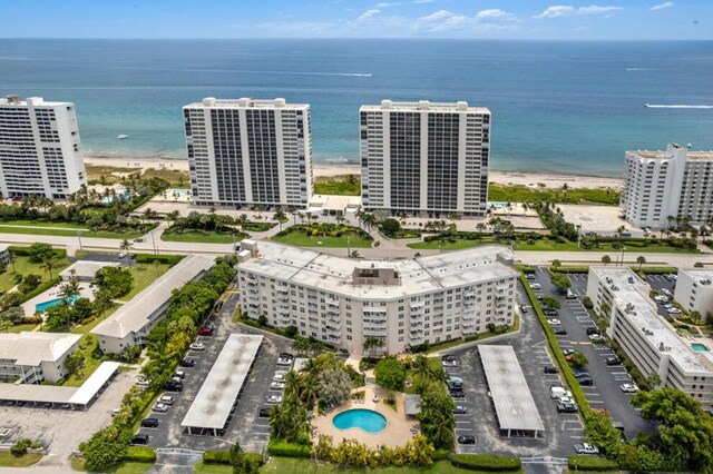 drone / aerial view featuring a water view and a beach view