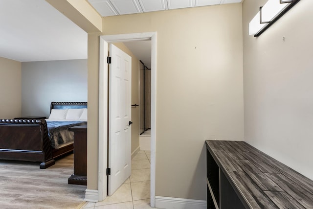 interior space featuring light tile patterned flooring and baseboards