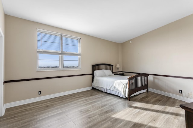 unfurnished bedroom with light wood-type flooring and baseboards