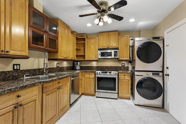 kitchen featuring open shelves, appliances with stainless steel finishes, light tile patterned flooring, a sink, and stacked washing maching and dryer