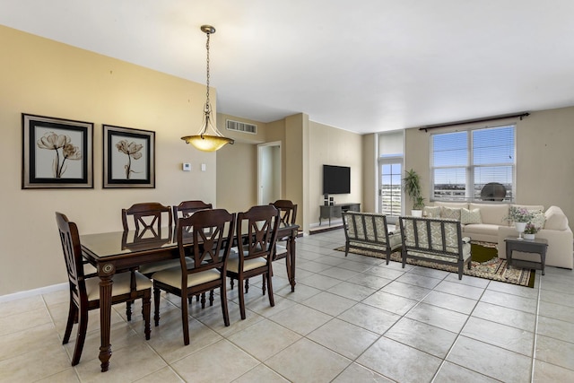 dining area with light tile patterned flooring, visible vents, and baseboards