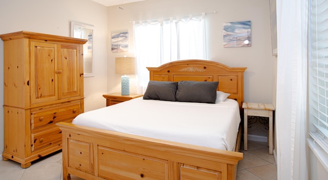 bedroom featuring light tile patterned flooring