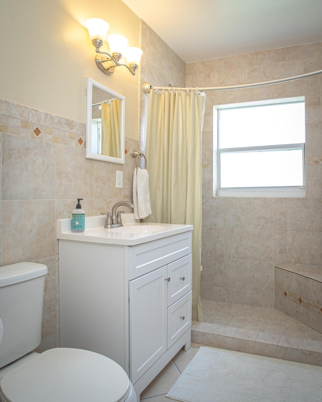 bathroom with tile walls, tile patterned flooring, vanity, toilet, and a shower with curtain