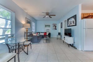 living room featuring light tile patterned flooring and ceiling fan