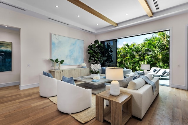 living room with light wood-type flooring and beam ceiling