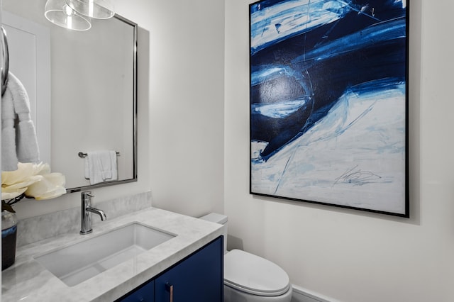 bathroom with toilet and vanity