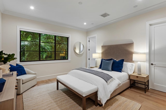 bedroom featuring light hardwood / wood-style floors and ornamental molding