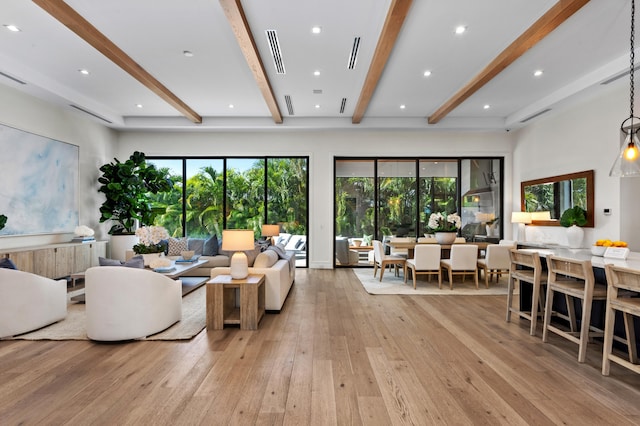 living room with beamed ceiling and light hardwood / wood-style flooring