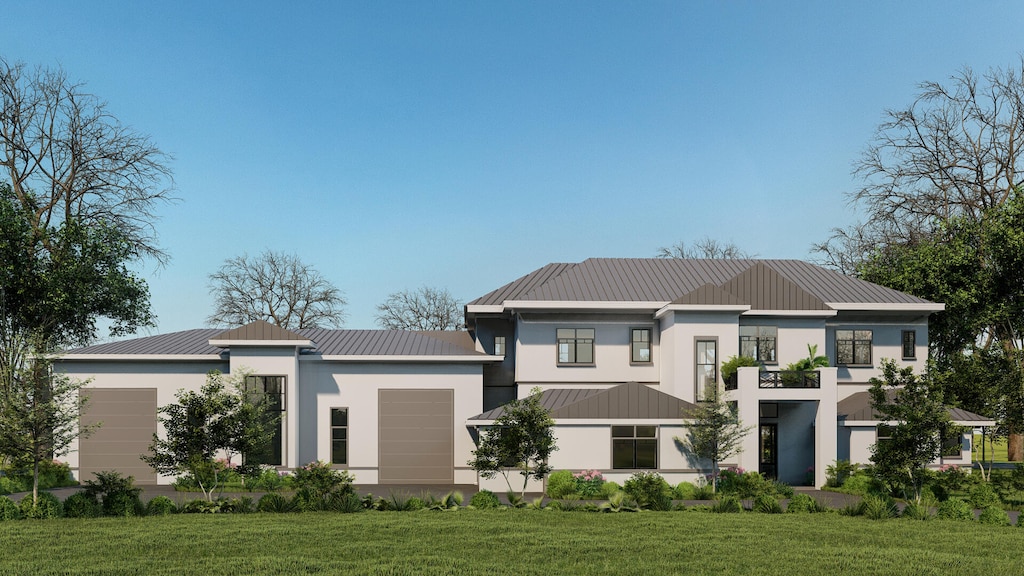 rear view of house with a garage and a yard