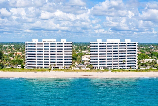 birds eye view of property with a water view and a view of the beach