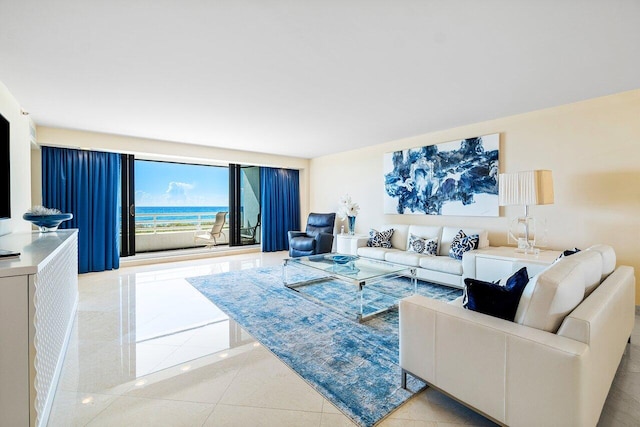 living room with a water view and light tile patterned floors