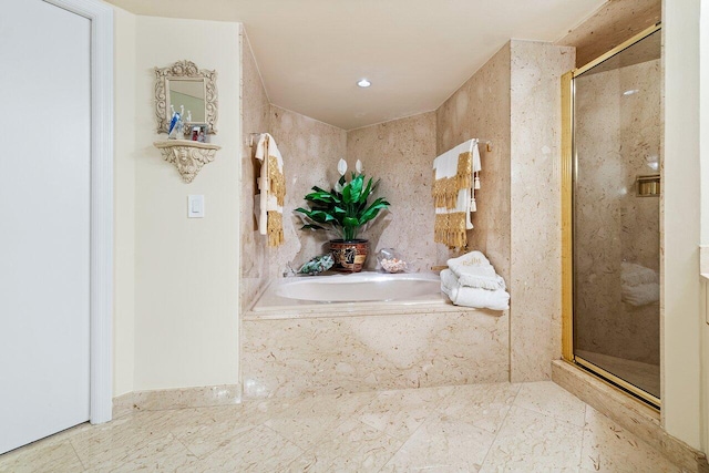 bathroom with independent shower and bath and tile patterned floors