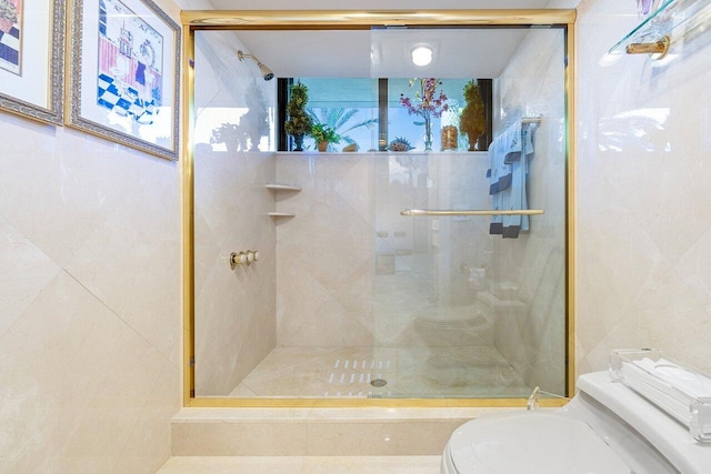 bathroom featuring walk in shower and toilet