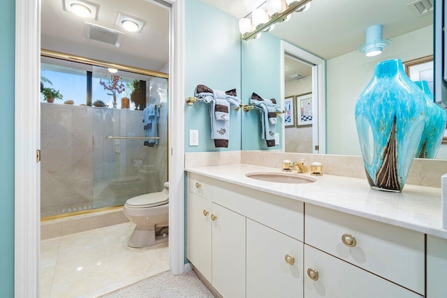 bathroom featuring an enclosed shower, tile patterned flooring, toilet, and vanity