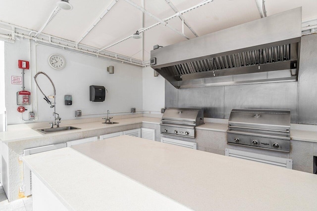 kitchen featuring white cabinetry and sink