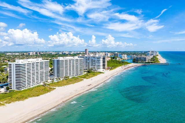 bird's eye view with a water view and a beach view