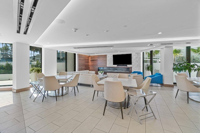 tiled dining area with a wall of windows