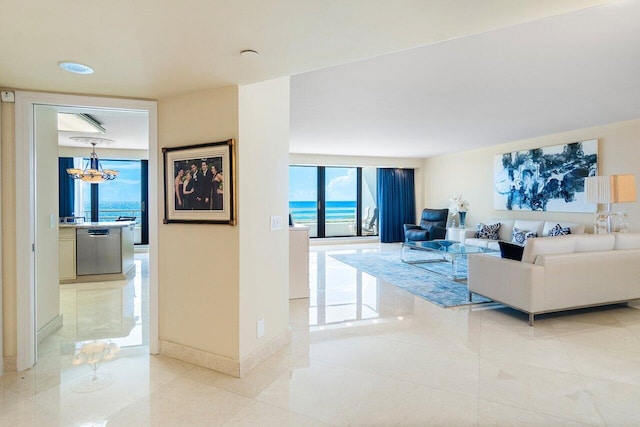 tiled living room featuring a water view and a notable chandelier