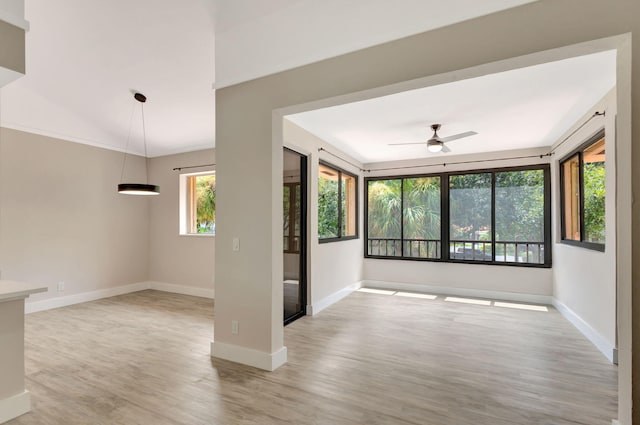 spare room featuring ceiling fan, wood finished floors, and baseboards