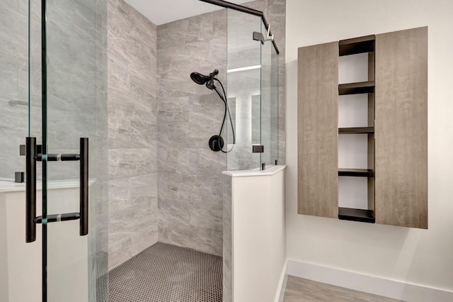 bathroom featuring hardwood / wood-style flooring and a shower with door