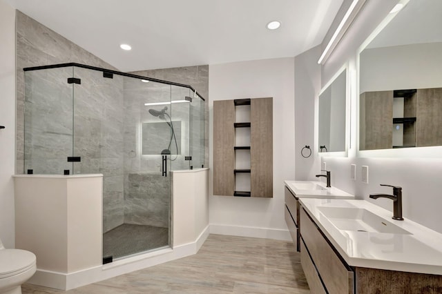 bathroom with walk in shower, hardwood / wood-style floors, vanity, and toilet