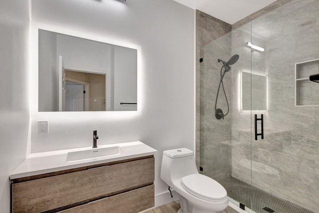 bathroom featuring hardwood / wood-style floors, a shower with shower door, vanity, and toilet