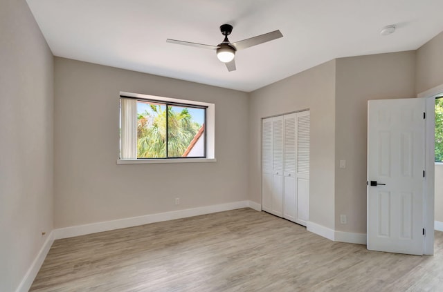 unfurnished bedroom featuring a closet, ceiling fan, and light hardwood / wood-style flooring