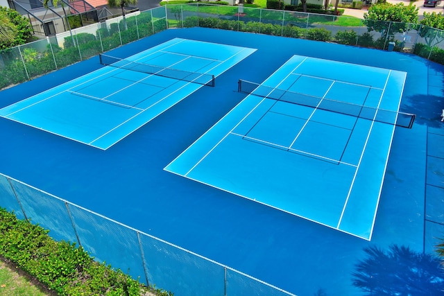 view of tennis court featuring fence
