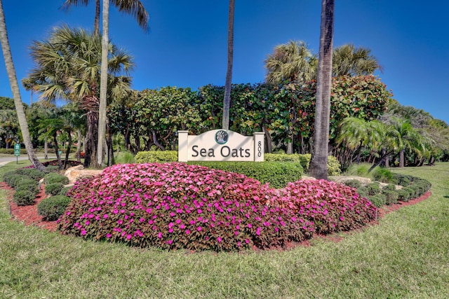 community sign featuring a lawn