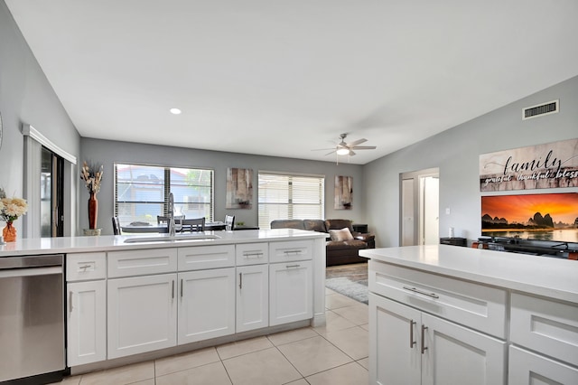 kitchen with vaulted ceiling, ceiling fan, sink, dishwasher, and white cabinets