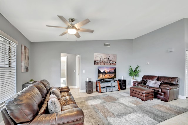 living room with light tile patterned floors, vaulted ceiling, and ceiling fan