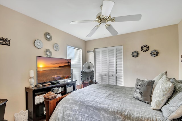 bedroom with ceiling fan and a closet