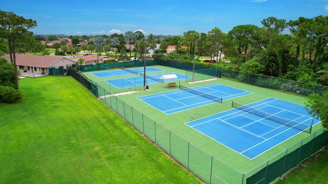 view of sport court with basketball hoop and a yard