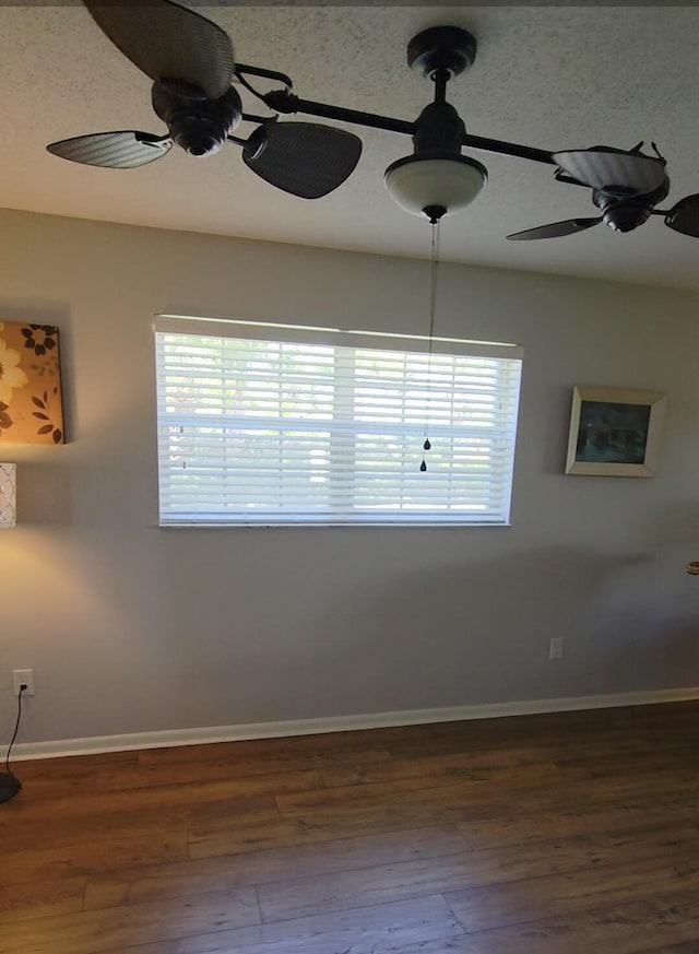 1854 SW Palm City Rd Unit 101, Stuart, FL 34994 - empty room with baseboards, dark wood-style floors, and a ceiling fan